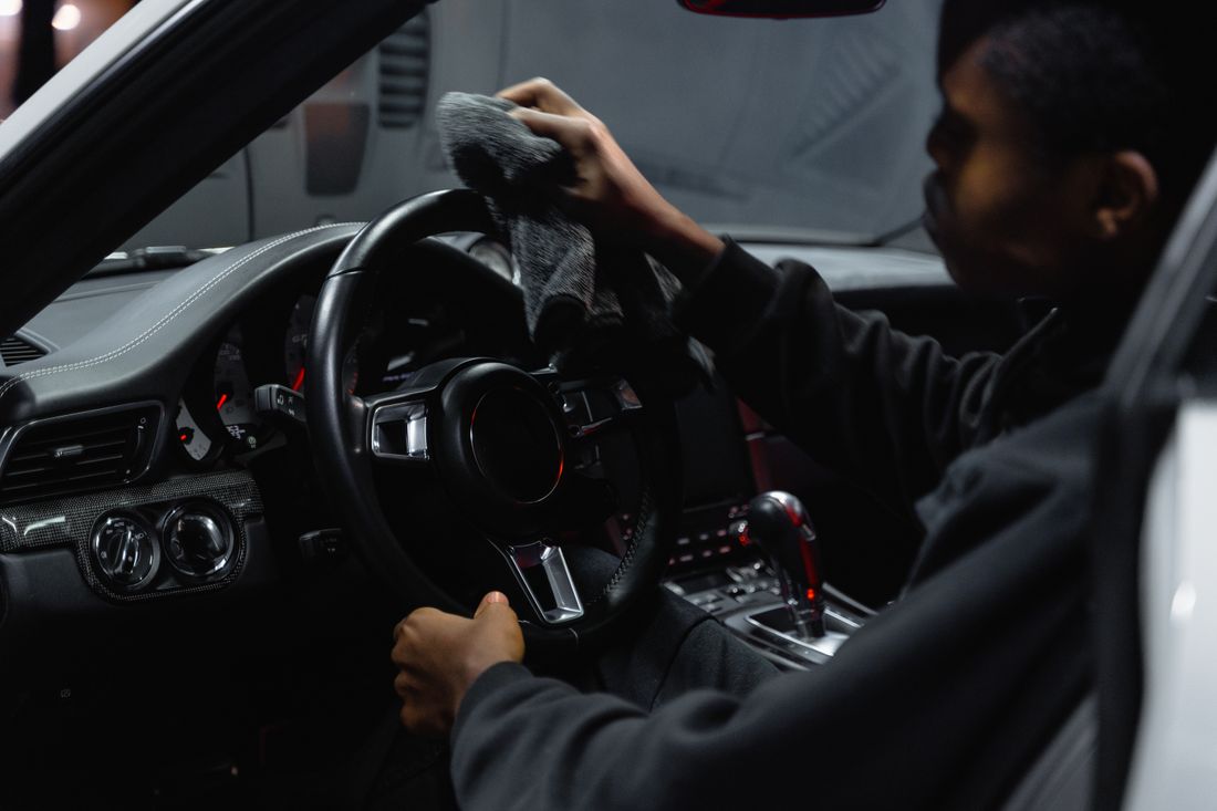 Detailer wiping down a steering wheel